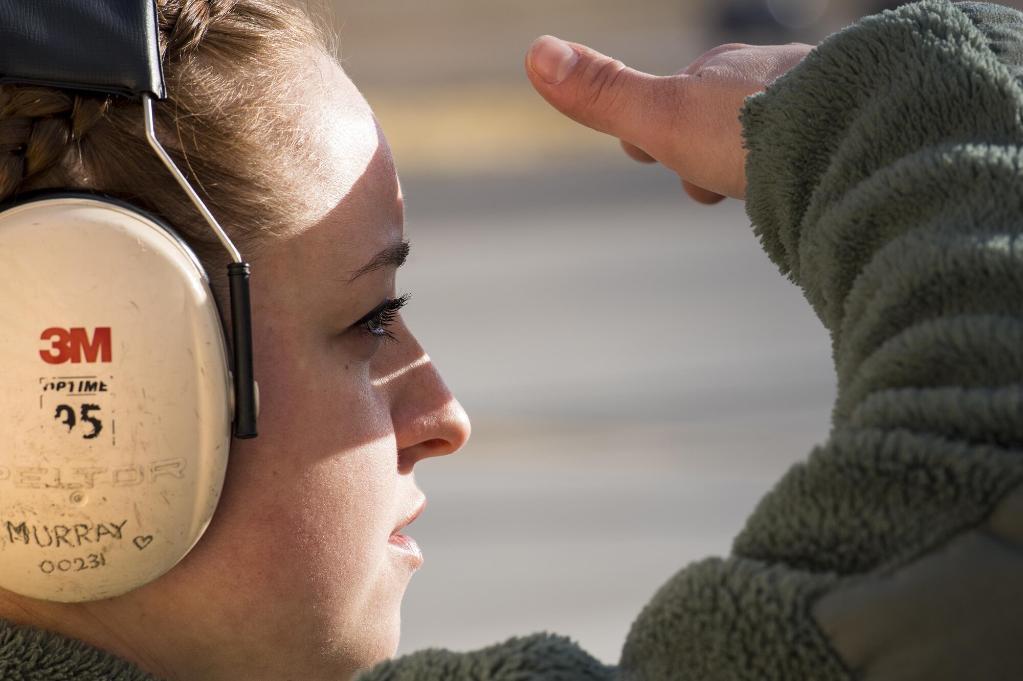 Airman First Class Kristen Murray, 74th Aircraft Maintenance Unit weapons load-team member, looks toward the flightline while waiting for an A-10C Thunderbolt II to return during Green Flag-West 17-03, Jan. 23, 2017, at Nellis Air Force Base, Nev. Weapons Airmen enabled joint force training during the two-week exercise by loading weapons, inspecting jets and maintaining munitions systems. Some of the live munitions included the Mark 82 and 84 general purpose bombs, high-explosive incendiary 30mm rounds and the 500 pound GBU-12 Paveway II laser-guided bomb. (U.S. Air Force photo by Staff Sgt. Ryan Callaghan)