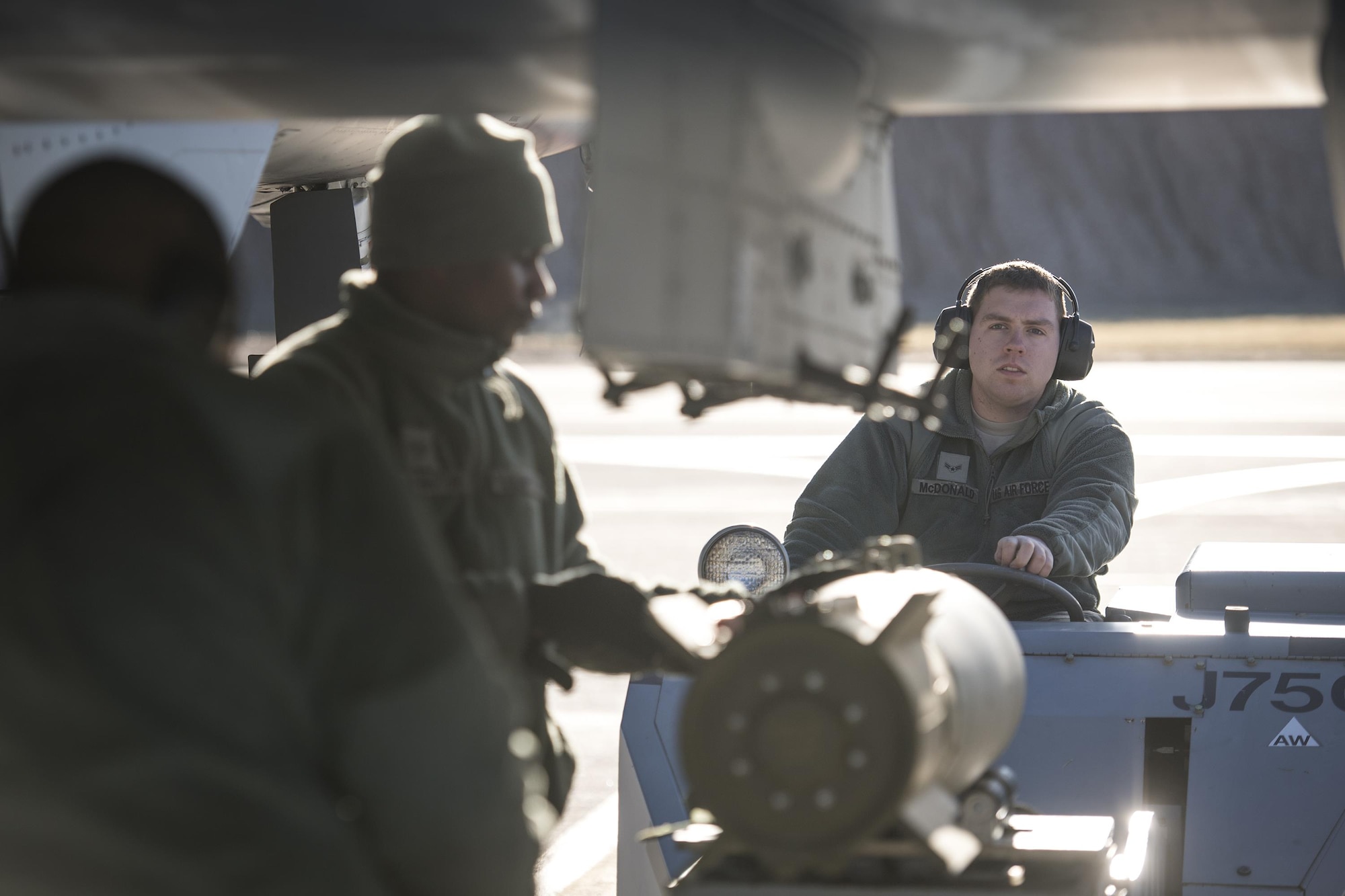Airman First Class Connor McDonald, 74th Aircraft Maintenance Unit weapons load team member, operates an MJ-1C bomb lift while weapons load team member guide a Mark 82 general purpose bomb to its place under an A-10C Thunderbolt II during Green Flag-West 17-03, Jan. 24, 2017, at Nellis Air Force Base, Nev. Weapons Airmen enabled joint force training during the two-week exercise by loading weapons, inspecting jets and maintaining munitions systems. Some of the live munitions included the Mark 82 and 84 general purpose bombs, high-explosive incendiary 30mm rounds and the 500 pound GBU-12 Paveway II laser-guided bomb. (U.S. Air Force photo by Staff Sgt. Ryan Callaghan)