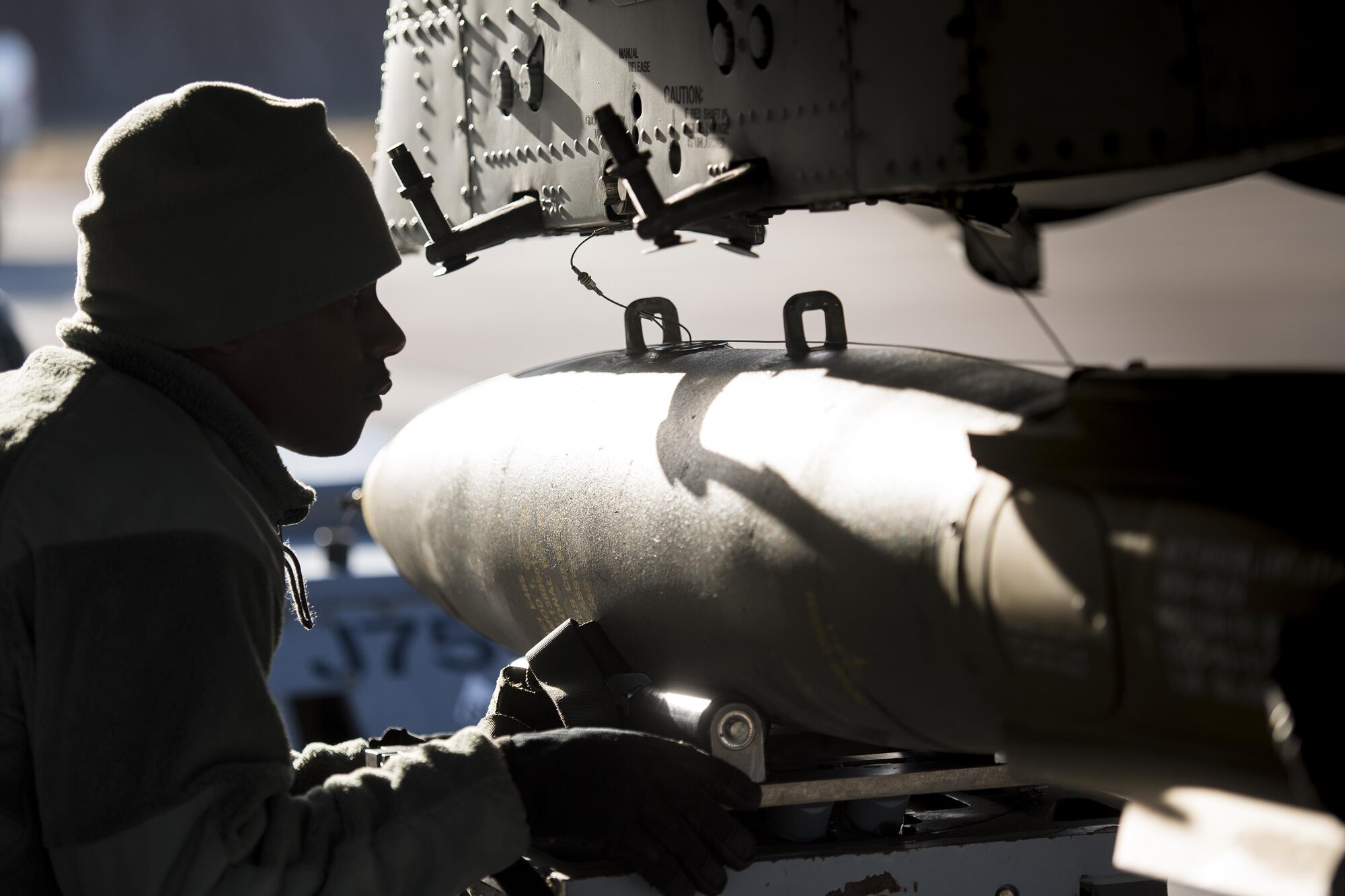 Staff Sgt. Tayrell Washington, 74th Aircraft Maintenance Unit weapons load team chief, guides a Mark 82 general purpose bomb into position underneath an A-10C Thunderbolt II during Green Flag-West 17-03, Jan. 24, 2017, at Nellis Air Force Base, Nev. Weapons Airmen enabled joint force training during the two-week exercise by loading weapons, inspecting jets and maintaining munitions systems. Some of the live munitions included the Mark 82 and 84 general purpose bombs, high-explosive incendiary 30mm rounds and the 500 pound GBU-12 Paveway II laser-guided bomb. (U.S. Air Force photo by Staff Sgt. Ryan Callaghan)