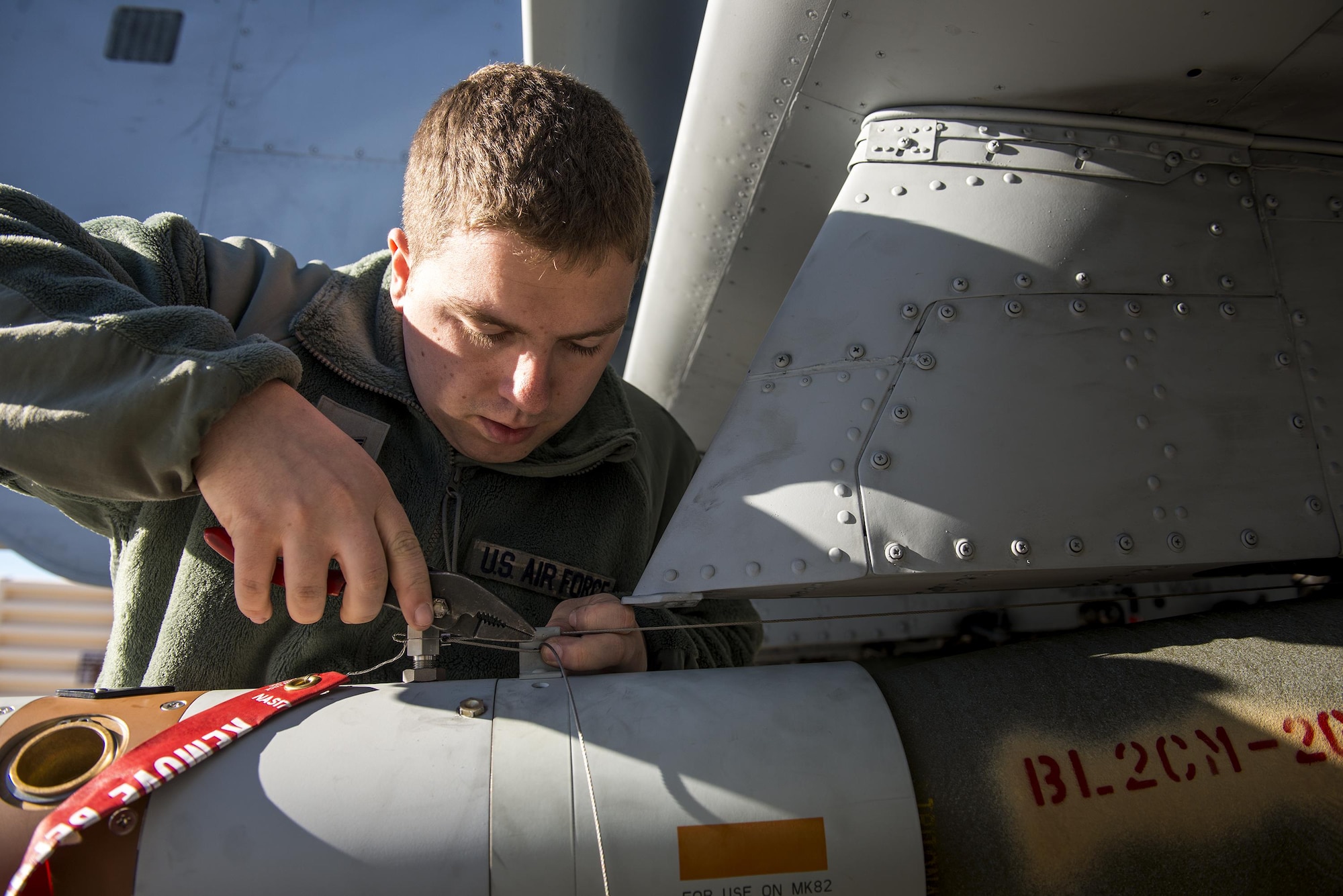 Airman First Class Connor McDonald, 74th Aircraft Maintenance Unit weapons load team member, installs an arming wire on a GBU-12 Paveway II laser-guided bomb during Green Flag-West 17-03, Jan. 24, 2017, at Nellis Air Force Base, Nev. Weapons Airmen enabled joint force training during the two-week exercise by loading weapons, inspecting jets and maintaining munitions systems. Some of the live munitions included the Mark 82 and 84 general purpose bombs, high-explosive incendiary 30mm rounds and the 500 pound GBU-12 Paveway II laser-guided bomb. (U.S. Air Force photo by Staff Sgt. Ryan Callaghan)