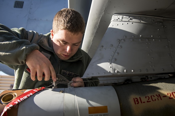 Airman First Class Connor McDonald, 74th Aircraft Maintenance Unit weapons load team member, installs an arming wire on a GBU-12 Paveway II laser-guided bomb during Green Flag-West 17-03, Jan. 24, 2017, at Nellis Air Force Base, Nev. Weapons Airmen enabled joint force training during the two-week exercise by loading weapons, inspecting jets and maintaining munitions systems. Some of the live munitions included the Mark 82 and 84 general purpose bombs, high-explosive incendiary 30mm rounds and the 500 pound GBU-12 Paveway II laser-guided bomb. (U.S. Air Force photo by Staff Sgt. Ryan Callaghan)
