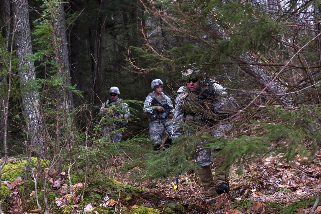National Guardsmen move through the woods during ambush training at the Camp Ethan Allen Training Site, Jericho, Vt., Jan. 23, 2017. Air National Guard photo by Tech. Sgt. Sarah Mattison