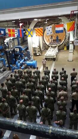 NEDU personnel stand in formation to listen to Vice Admiral Moore speak.