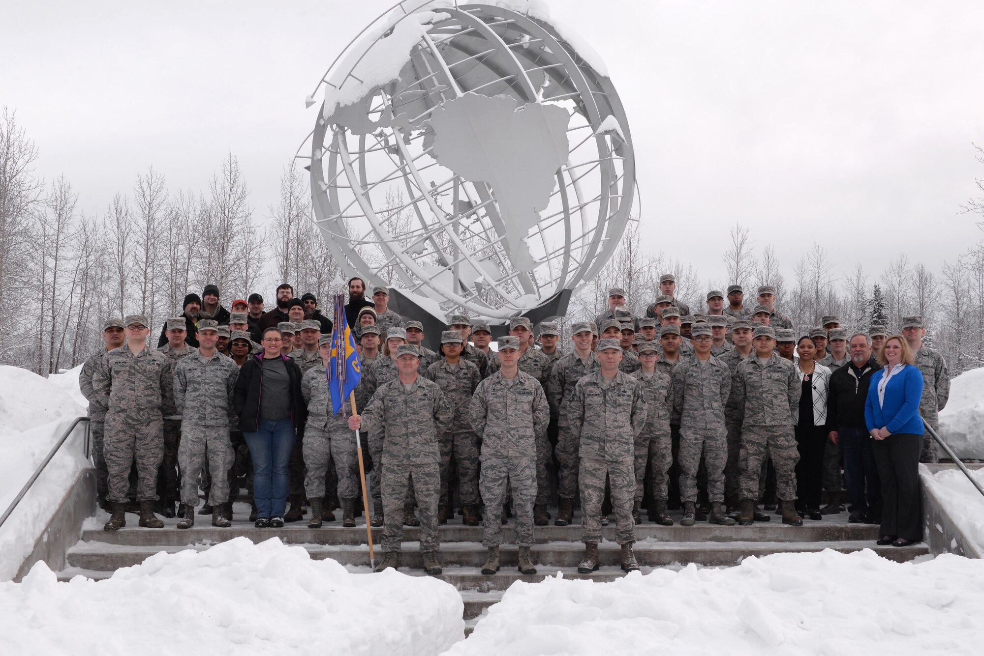 U.S. Air Force Airmen and civilians assigned to the 354th Communications Squadron (CS) pose for a group photo in the snow Jan. 26, 2017, at Eielson Air Force Base, Alaska. The 354th CS won the Air Force Lieutenant General Harold W. Grant Award for small communications unit. (U.S. Air Force photo by Airman 1st Class Cassandra Whitman)