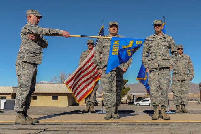 The 57th Munitions Squadron guidon is displayed after its unfurling during a redesignation ceremony at Nellis Air Force Base, Nev., Jan. 27, 2017. The 57th Maintenance Squadron was inactivated and the 57th MUNS took its place to better align the unit with its primary mission.