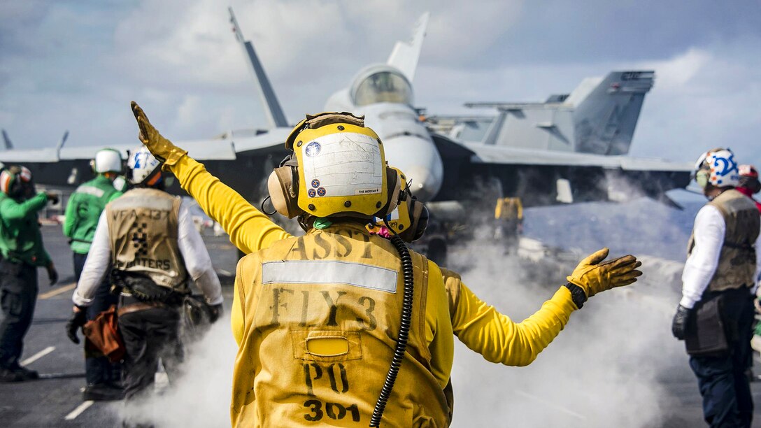 Sailors use hand signals while conducting flight operations on the flight deck aboard the aircraft carrier USS Carl Vinson in the Pacific Ocean, Jan. 25, 2017. The Carl Vinson Carrier Strike Group will report to U.S. 3rd Fleet, headquartered in San Diego, while deployed to the Western Pacific as part of the U.S. Pacific Fleet-led initiative to extend the command and control functions of 3rd Fleet into the region. Navy photo by Petty Officer 2nd Class Sean M. Castellano