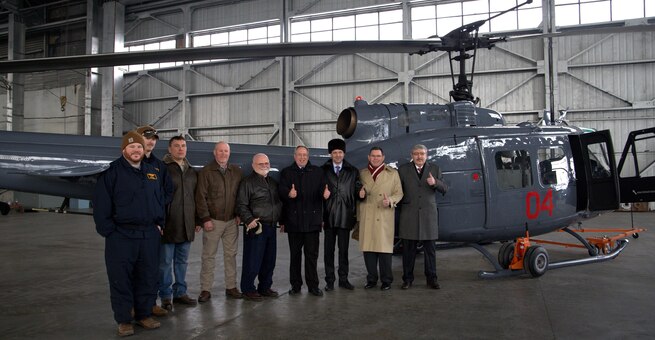 ALMATY, Kazakhstan (Jan. 27, 2017) U.S.Ambassador to Kazakhstan, George Krol, fourth from right, Consul General Mark Moody, second from right, Plant 405 managers, and leadership of the Ministry of Defense pose for a group photo during a ceremony handing over a Huey II Helicopter to the Ministry of Defense of Kazakhstan. This is the fourth Huey helicopter provided to Kazakhstan through the U.S. Foreign Military Sales Program. (Courtesy photo)