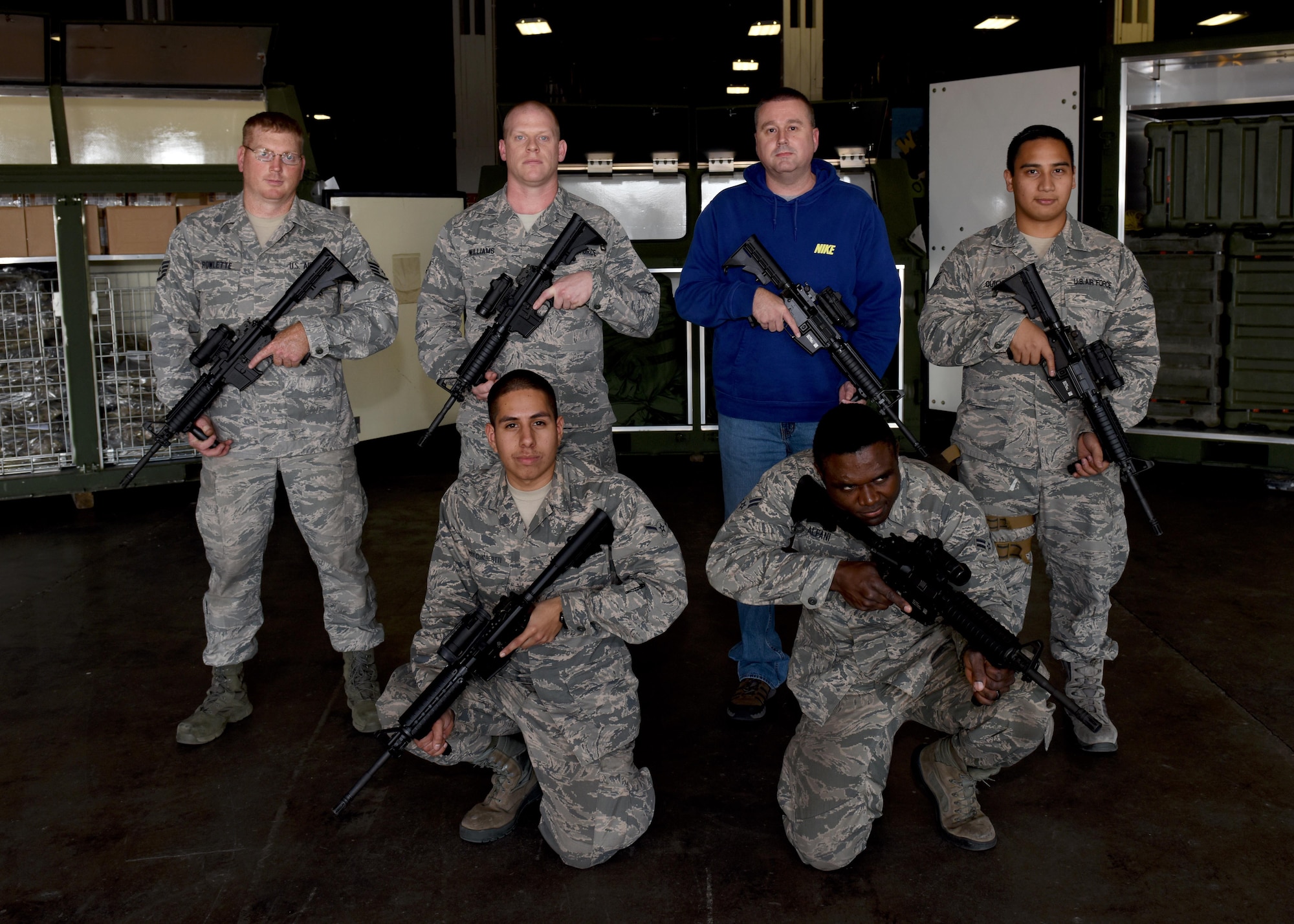 Members of the individual protective equipment shop assigned to the 509th Logistics Readiness Squadron (LRS) display the weapons and gear involved in the most stringent contingency deployment operation at Whiteman Air Force Base, Mo., Nov. 14, 2016. The shop was awarded January 2017 team of the month for LRS. (U.S. Air Force photo by Senior Airman Danielle Quilla)