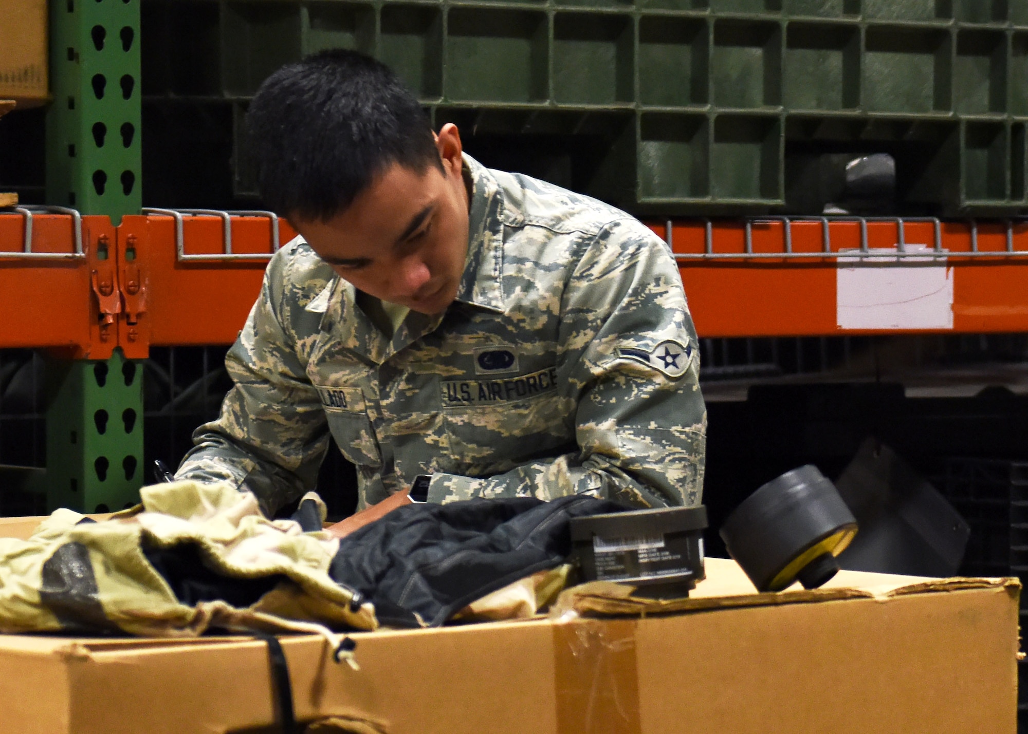 U.S. Air Force Airman Joerimer Collado, an individual protective equipment (IPE) specialist assigned to the 509th Logistics Readiness Squadron (LRS), creates an inventory list for disposition items at Whiteman Air Force Base, Mo., Jan. 17, 2017. When items are no longer needed in the IPE shop they are put into crates to be transferred to another facility. (U.S. Air Force photo by Senior Airman Danielle Quilla)