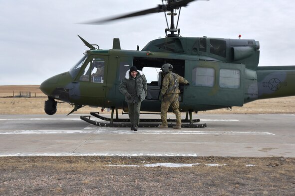 U.S. Navy Vice Adm. Charles “Chas” A. Richard, U.S. Strategic Command deputy commander, exits a UH-1N Huey at a missile alert facility in the 90th Missile Wing missile complex, Jan. 26, 2017. Richard toured a MAF, which gave him insight to the responsibilities of the Airmen supporting the nation’s nuclear deterrence mission. (U.S. Air Force photo by Airman 1st Class Breanna Carter)
