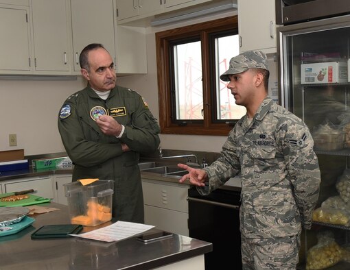 Airman 1st Class Lazaro Gonzalez, 90th Force Support Squadron missile chef, explains his responsibilities to U.S. Navy Vice Adm. Charles “Chas” A. Richard, U.S. Strategic Command deputy commander, at a missile alert facility in the 90th Missile Wing missile complex, Jan. 26, 2017. Gonzalez is responsible for providing meals to personnel at the missile alert facility. (U.S. Air Force photo by Airman 1st Class Breanna Carter) 