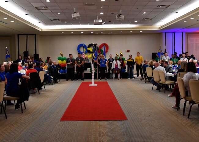 The 628th Air Base Wing annual award nominees stand with their guidons during the 628th Air Base Wing Annual Awards Ceremony at the Charleston Club, Jan. 27, 2017. These gold-medal Airmen and Sailors were recognized at the Olympic-themed event for their hard work throughout 2016.