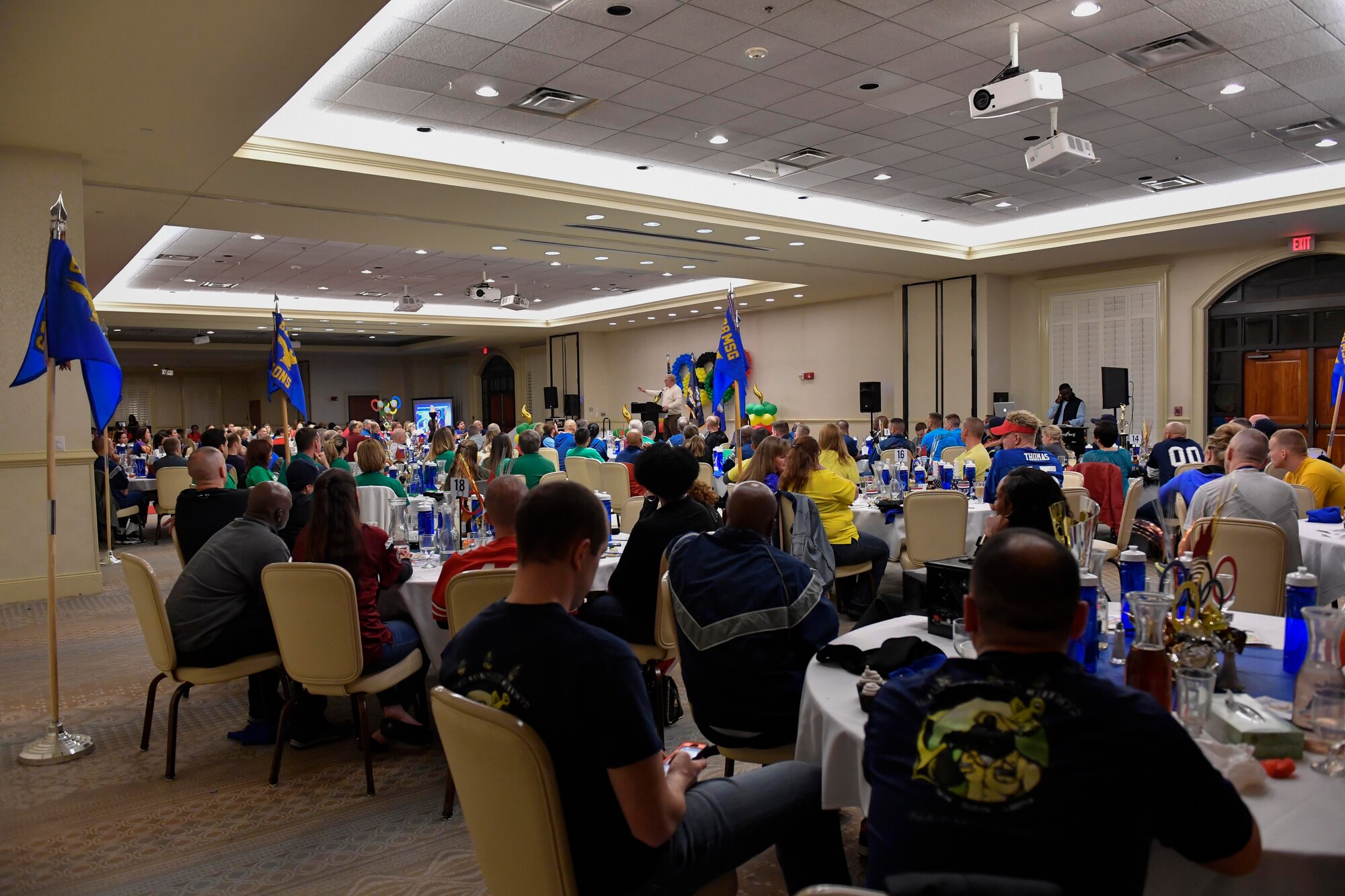 Members of Team Charleston listen to Cal McCombs, the guest speaker, at the 628th Air Base Wing Annual Awards ceremony at the Charleston Club, Jan. 27, 2017. Gold-medal Airmen and Sailors were recognized during the Olympic-themed event for their hard work throughout 2016.