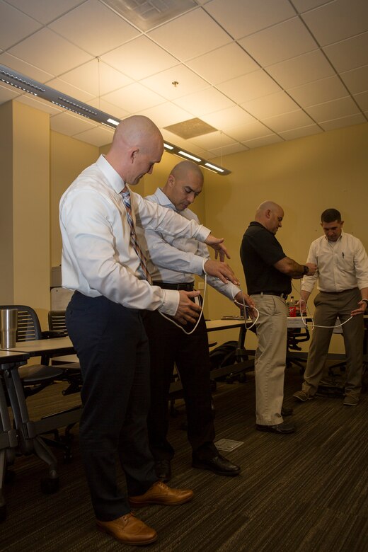 Senior leaders from across Marine Forces Reserve work on untangling themselves while participating in an exercise during the Senior Leadership Workshop at Marine Corps Support Facility New Orleans, Jan. 23-26, 2017. The Marines and Sailors participated in multiple exercises and discussions that address differences in leadership styles, perspectives, experiences, backgrounds and more. The workshop aims to emphasize the importance of open communication and equal opportunity, and to demonstrate their effects on unit cohesion, mission accomplishment and mission readiness. (U.S. Marine Corps photo by Sgt. Sara Graham) 