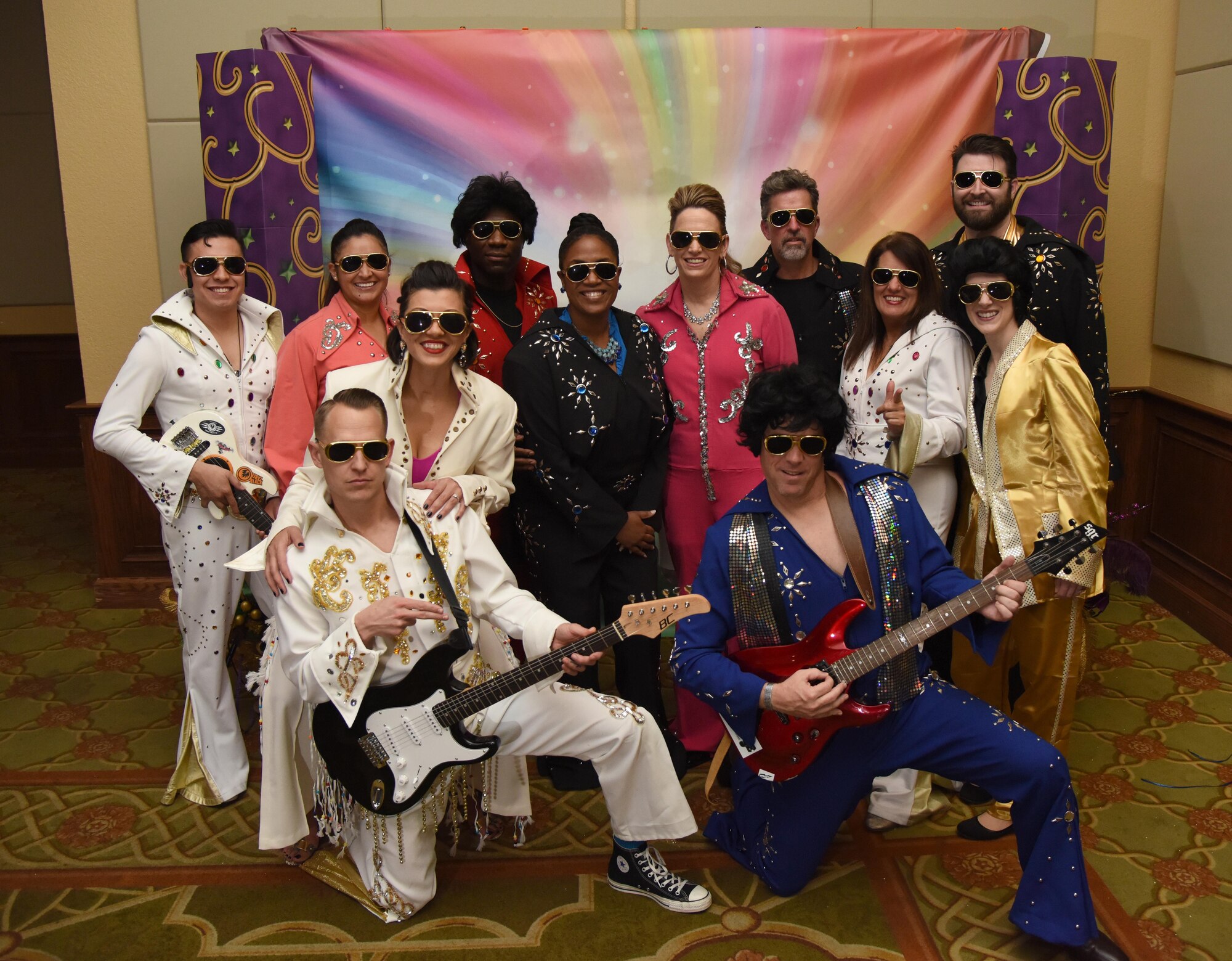 Col. Michele Edmondson , 81st Training Wing commander, members of the 81st TRW command staff and their spouses, dressed as Elvis, pose for a group photo at the 29th Annual Krewe of Medics Mardi Gras Ball at the Bay Breeze Event Center Jan. 28, 2017, on Keesler Air Force Base, Miss. The Krewe of Medics hosts a yearly ball to give Keesler Medical Center personnel a taste of the Gulf Coast and an opportunity to experience a traditional Mardi Gras. The theme for this year's ball was Blast From The Past. (U.S. Air Force photo by Kemberly Groue)
