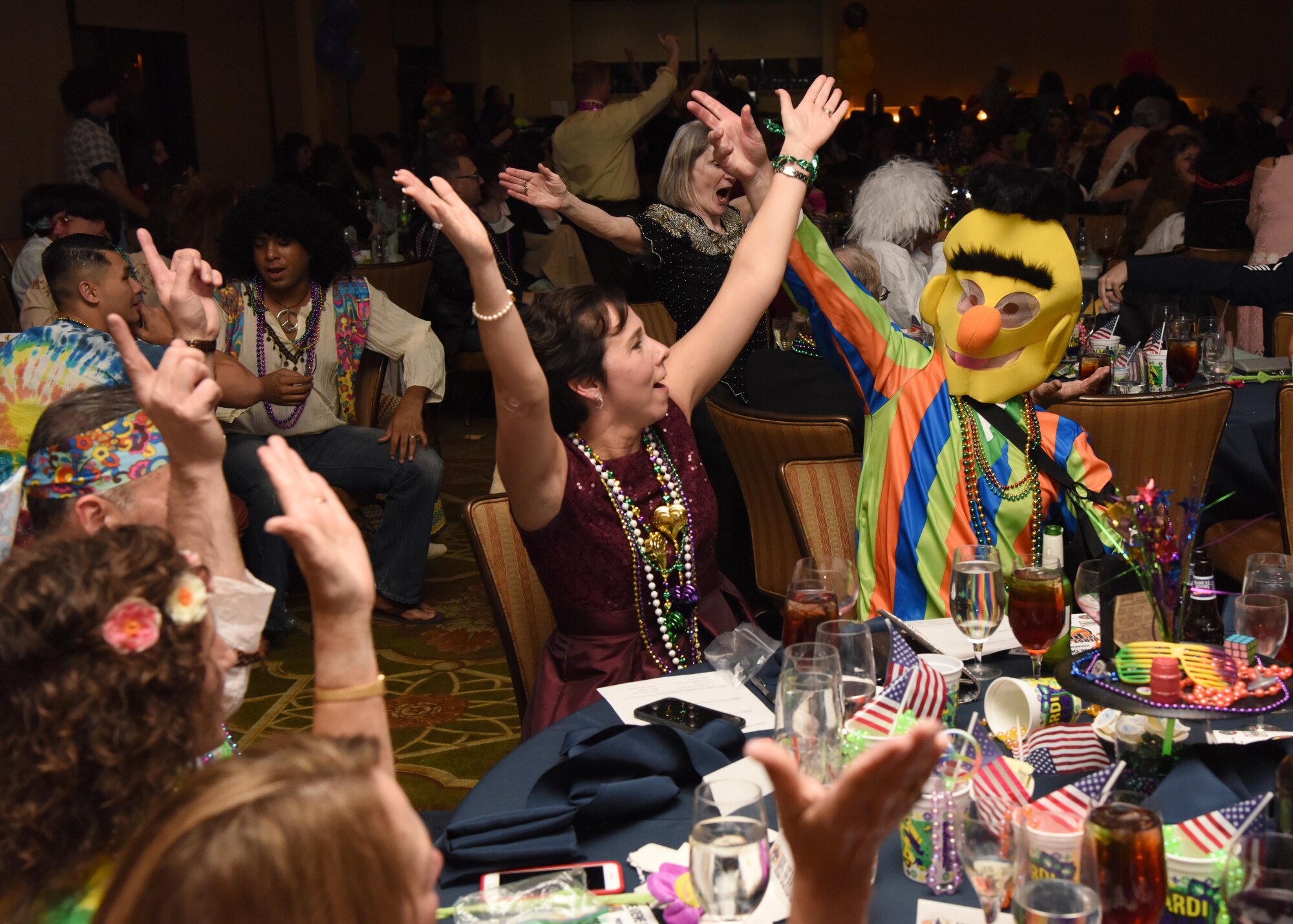 Col. Jeannine Ryder, 81st Medical Group commander, and Chief Master Sgt. Karl Day, 81st MDG superintendent, participate in a “YMCA” dance during the 29th Annual Krewe of Medics Mardi Gras Ball at the Bay Breeze Event Center Jan. 28, 2017, on Keesler Air Force Base, Miss. The Krewe of Medics hosts a yearly ball to give Keesler Medical Center personnel a taste of the Gulf Coast and an opportunity to experience a traditional Mardi Gras. The theme for this year's ball was Blast From The Past. (U.S. Air Force photo by Kemberly Groue)