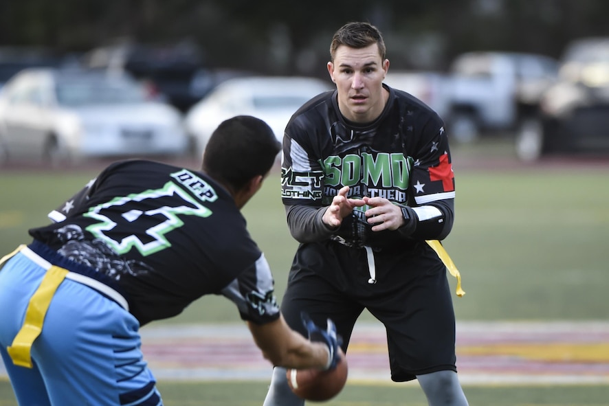 Jerime Gorse, the quarterback for the 1st Special Operations Medical Group intramural flag football team, awaits the snap from Miguel De Castro, playing center for the 1st SOMDG, during the flag football championship at Hurlburt Field, Fla., Jan. 26, 2017. More than 24 teams competed in approximately 74 games during the season. (U.S. Air Force photo by Airman 1st Class Joseph Pick)