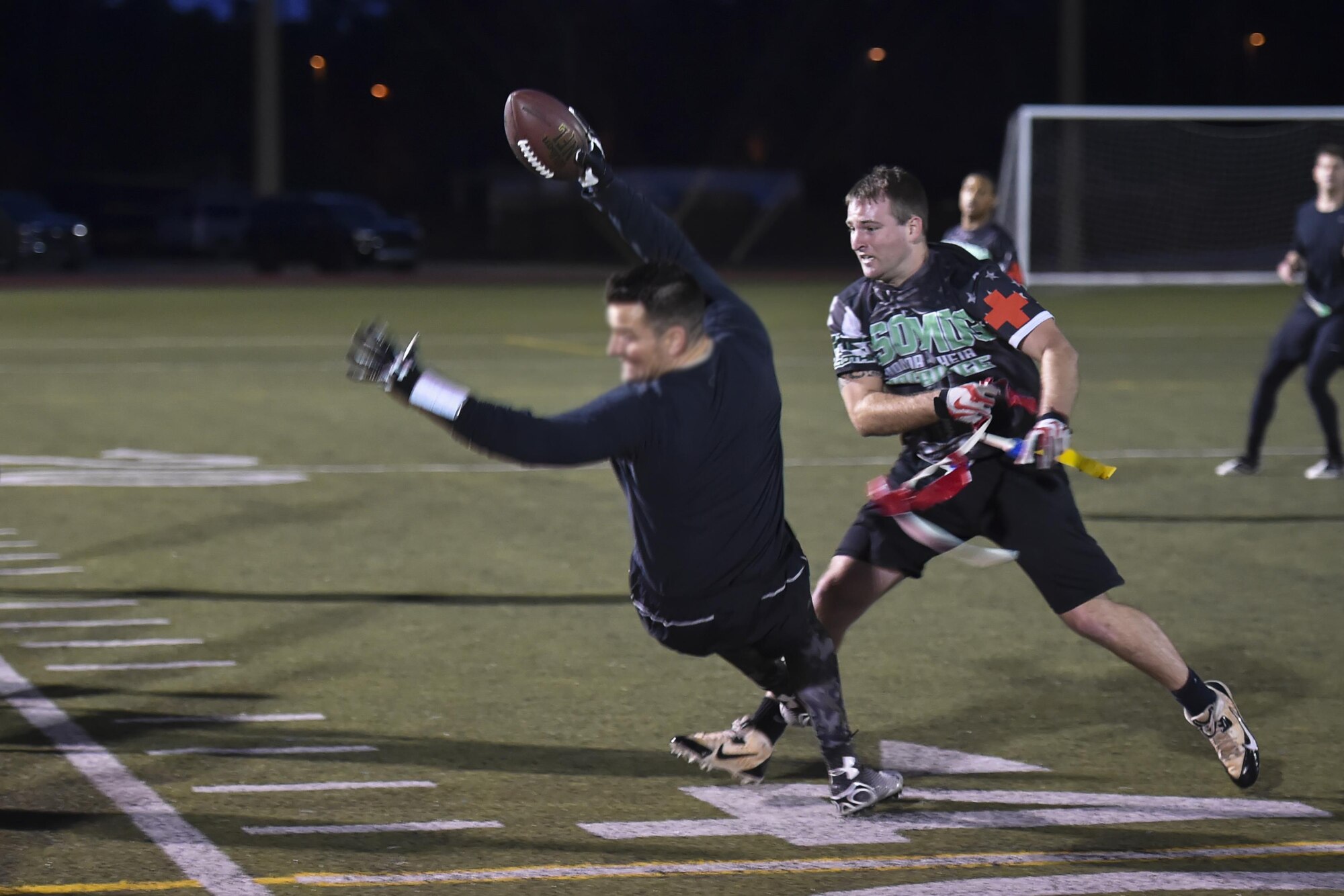 Christopher Mauldin, a defensive player for the 1st Special Operations Medical Group intramural flag football team, pulls the flag of a receiver for the 23rd Special Tactics Training Squadron team during the flag football championship at Hurlburt Field, Fla., Jan. 26, 2017. The 1st SOMDG defeated the 23rd STTS by the score of seven to six. (U.S. Air Force photo by Airman 1st Class Joseph Pick)