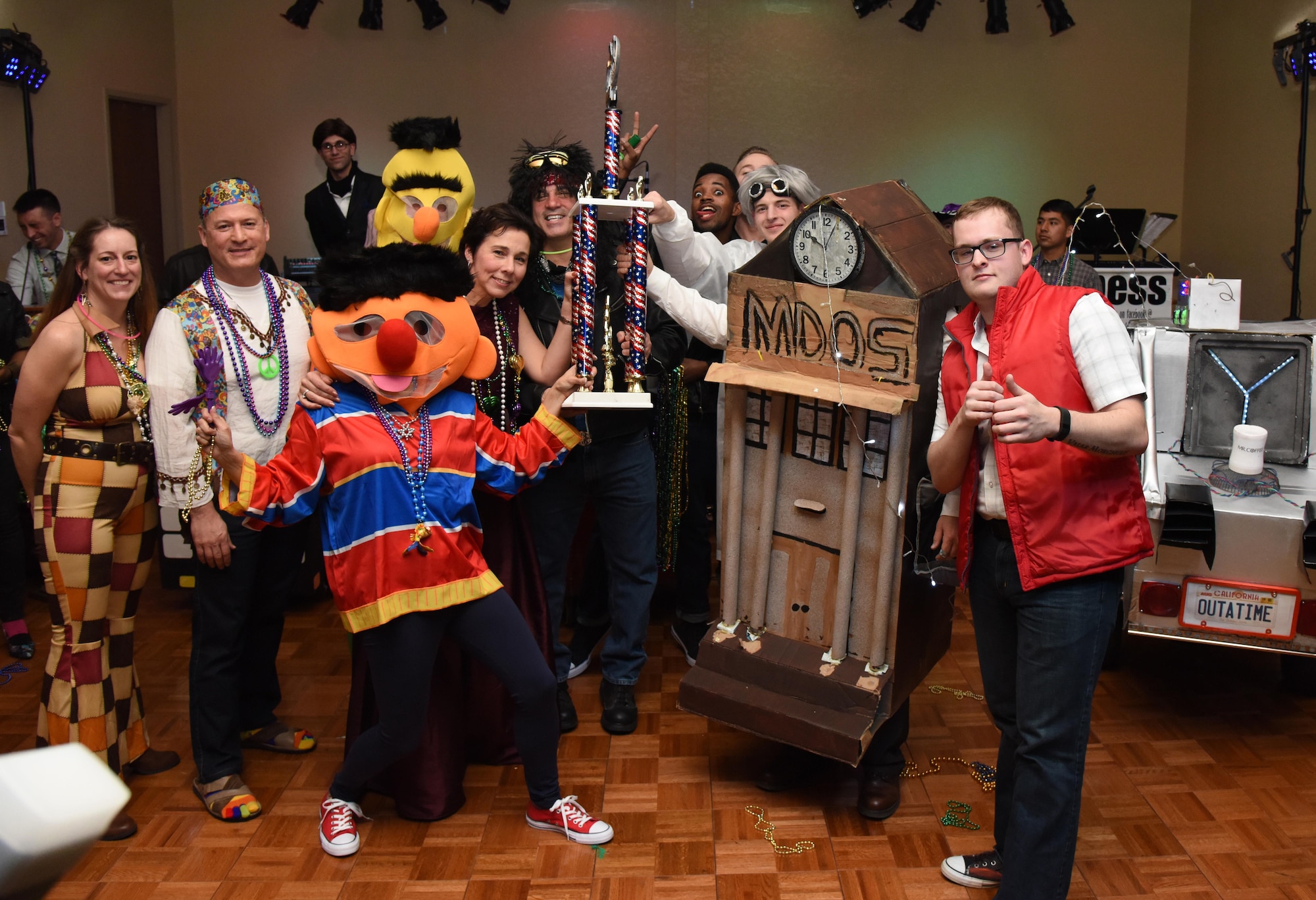 Members of the 81st Medical Operations Squadron receive the first place first place trophy in the Mardi Gras float contest during the 29th Annual Krewe of Medics Mardi Gras Ball at the Bay Breeze Event Center Jan. 28, 2017, on Keesler Air Force Base, Miss. The Krewe of Medics hosts a yearly ball to give Keesler Medical Center personnel a taste of the Gulf Coast and an opportunity to experience a traditional Mardi Gras. The theme for this year's ball was Blast From The Past. (U.S. Air Force photo by Kemberly Groue)