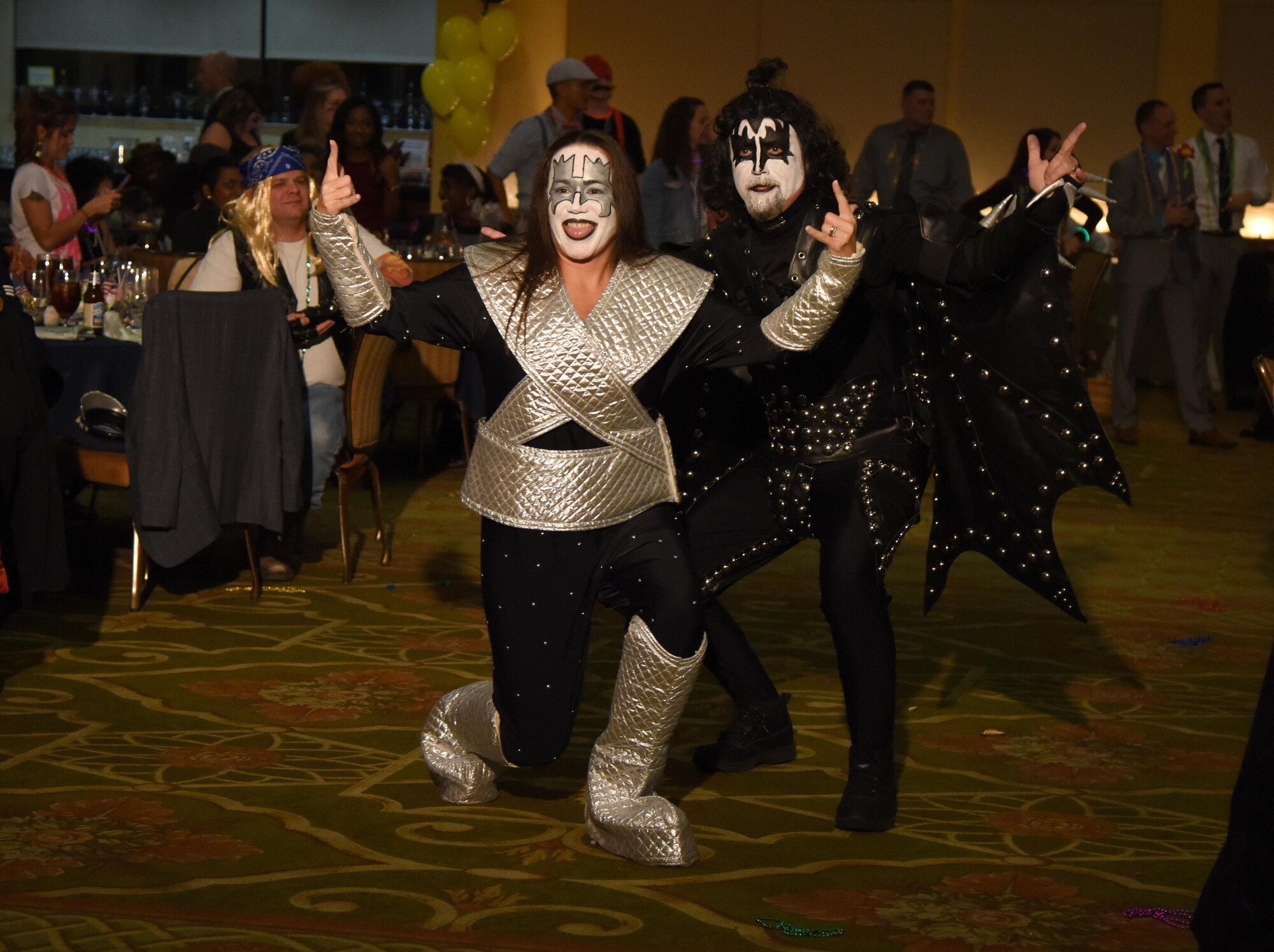 Chief Master Sgt. Tarah Baxley, 81st Diagnostic and Therapeutics Squadron superintendent, and her husband, retired Senior Master Sgt. James Baxley, portray members of the band, KISS, during a costume contest at the 29th Annual Krewe of Medics Mardi Gras Ball at the Bay Breeze Event Center Jan. 28, 2017, on Keesler Air Force Base, Miss. The Krewe of Medics hosts a yearly ball to give Keesler Medical Center personnel a taste of the Gulf Coast and an opportunity to experience a traditional Mardi Gras. The theme for this year's ball was Blast From The Past. (U.S. Air Force photo by Kemberly Groue)