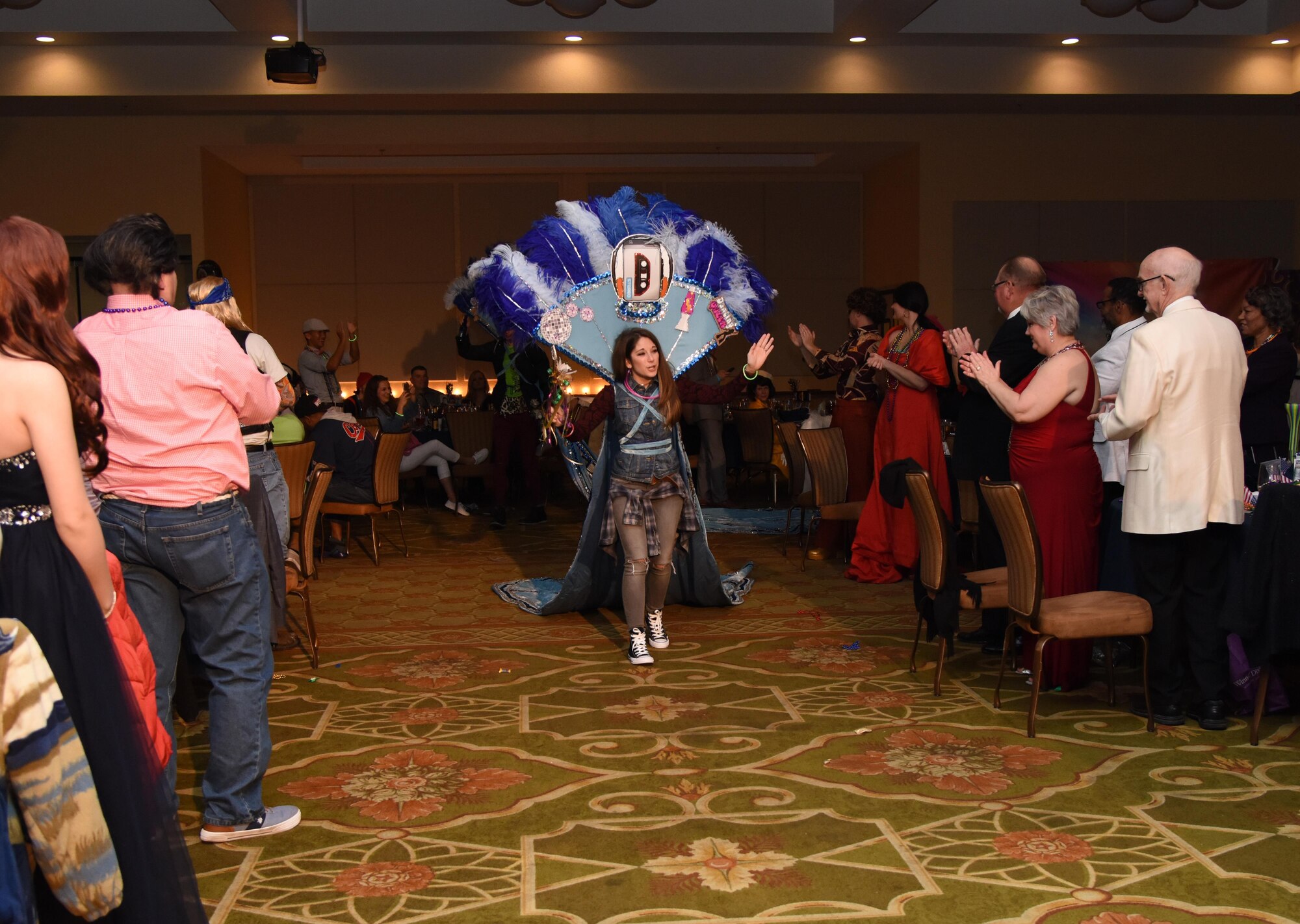 Capt. Francesca Culp, 81st Surgical Operations Squadron occupational therapy doctor, waves to the crowd after being named the 2017 Krewe of Medics Queen during the 29th Annual Krewe of Medics Mardi Gras Ball at the Bay Breeze Event Center Jan. 28, 2017, on Keesler Air Force Base, Miss. The Krewe of Medics hosts a yearly ball to give Keesler Medical Center personnel a taste of the Gulf Coast and an opportunity to experience a traditional Mardi Gras. The theme for this year's ball was Blast From The Past. (U.S. Air Force photo by Kemberly Groue)