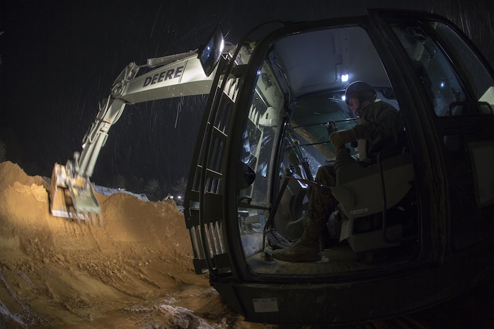 U.S. Marine Corps Pfc. Coe Vandivier, a heavy equipment operator with Marine Wing Support Squadron (MWSS) 171, operates a hydraulic excavator during exercise Kamoshika Wrath 17-1 at Haramura Maneuver Area, Hiroshima, Japan, Jan. 26, 2017. The Marines worked through inclement weather conditions and a short timeline to build a 96-foot by 96-foot vertical takeoff and landing pad. The exercise is a biannual, unit-level training exercise that is primarily focused on establishing a forward operating base and providing airfield operation services. MWSS-171 trains throughout the year completing exercises like Kamoshika Wrath to enhance their technical skills, field experience and military occupational specialty capability. (U.S. Marine Corps photo by Cpl. Donato Maffin)