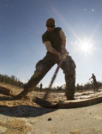 U.S. Marine Corps Cpl. Joseph Butler, an expeditionary airfield technician with Marine Wing Support Squadron (MWSS) 171, assembles a section of aluminum matting during exercise Kamoshika Wrath 17-1 at Haramura Maneuver Area, Hiroshima, Japan, Jan. 26, 2017. The Marines worked through inclement weather conditions and a short timeline to build a 96-foot by 96-foot vertical takeoff and landing pad. The exercise is a biannual, unit-level training exercise that is primarily focused on establishing a forward operating base and providing airfield operation services. MWSS-171 trains throughout the year completing exercises like Kamoshika Wrath to enhance their technical skills, field experience and military occupational specialty capability.   (U.S. Marine Corps photo by Cpl. Donato Maffin)