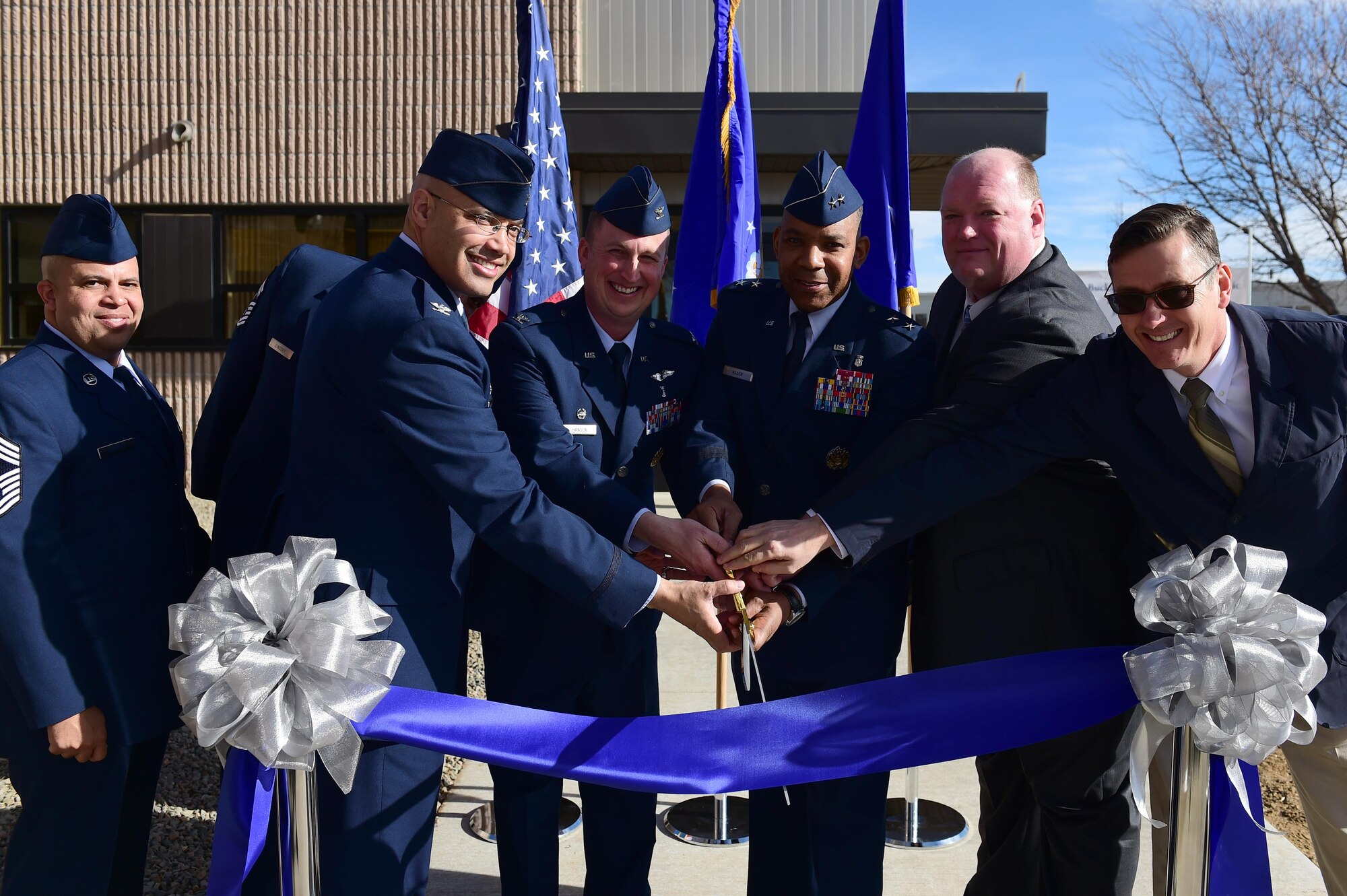 From left to right, Chief Master Sgt. Randy Lightsey, Dental Corps functional manager at Joint-Base San Antonio, Texas, Col. David Miller Jr., 460th Space Wing commander, Col. Matthew Hanson, 460th Medical Group commander, Maj. Gen. Roosevelt Allen, Medical Operations and Research Director and Chief of the Dental Corps Office of the Surgeon General in Washington D.C., Mark Spradling, Doyon Construction Group program manager, Neal Parker, engineer at U.S. Army Corps of Engineers, cut the ribbon at the grand opening of the dental clinic Jan. 30, 2017, on Buckley Air Force Base, Colo. The clinic will consist of 21 active-duty employees and will treat over 3,500 active-duty military members. (U.S. Air Force photo by Airman Jacob Deatherage/Released)