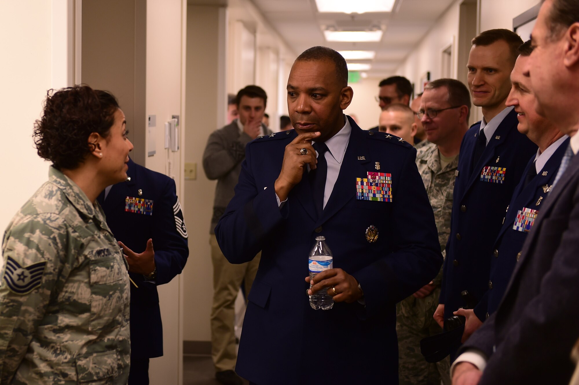 Maj. Gen. Roosevelt Allen, Medical Operations and Research Director and Chief of the Dental Corps Office of the Surgeon General in Washington D.C., listens to Tech. Sgt. Jacqueline Woodard, 460th Medical Group dental technician, on Buckley Air Force Base, Colo. Prior to the opening of the dental clinic, Buckley beneficiaries were required to receive treatment at off-base facilities. (U.S. Air Force photo by Airman Jacob Deatherage/Released)