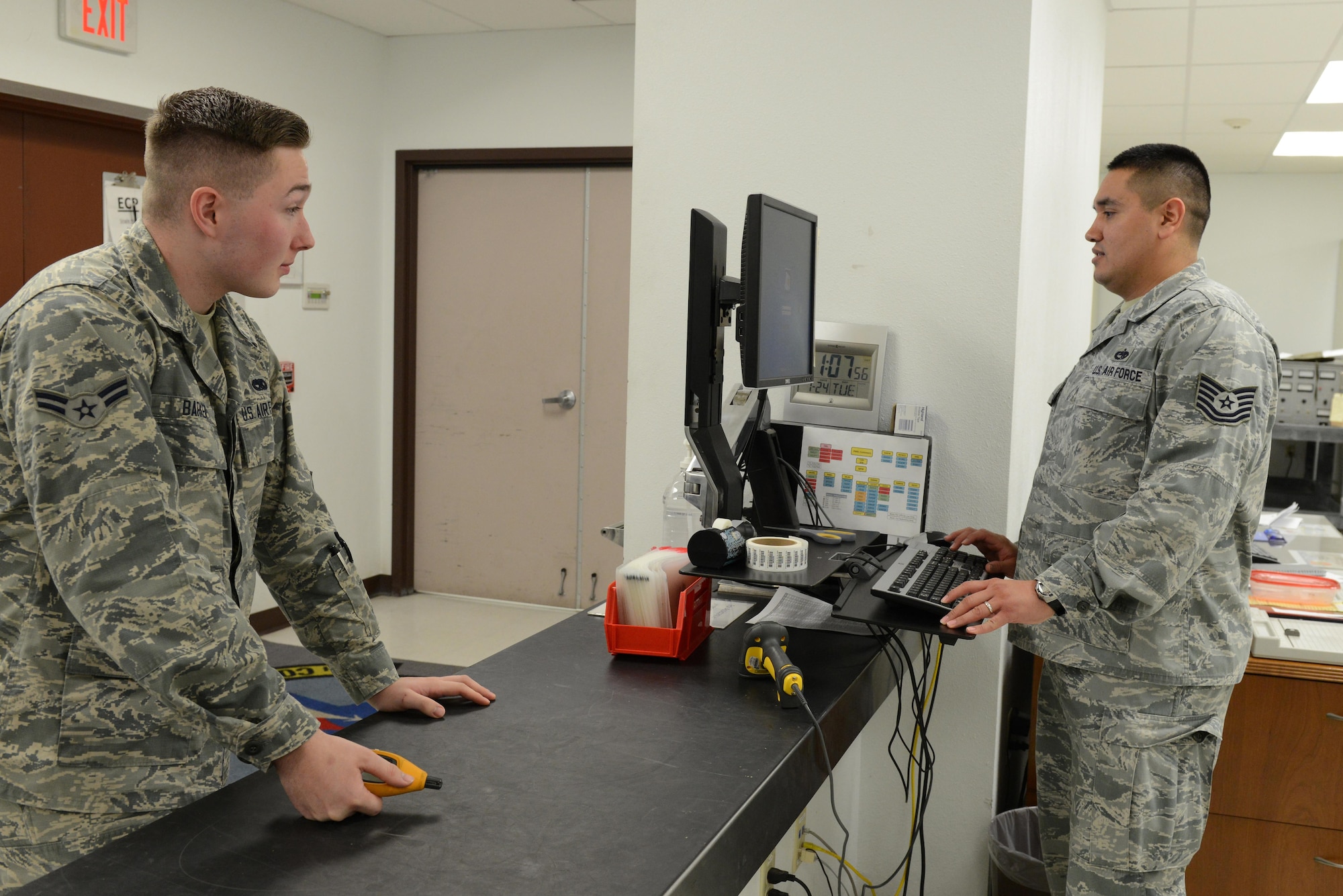 Airman 1st Class Jordan Barker, 56th Component Maintenance Squadron precision measurement equipment laboratory technician, and Tech. Sgt. Miguel Ruiz, 56th CMS noncommissioned officer-in-charge of production control, simulate a test measurement diagnostic equipment procedure Jan. 24, 2017, at Luke Air Force Base, Ariz. The TMDE is used to create a job control number which is the beginning stages of getting an item recalibrated.(U.S. Air Force photo by Airman 1st Class Pedro Mota)