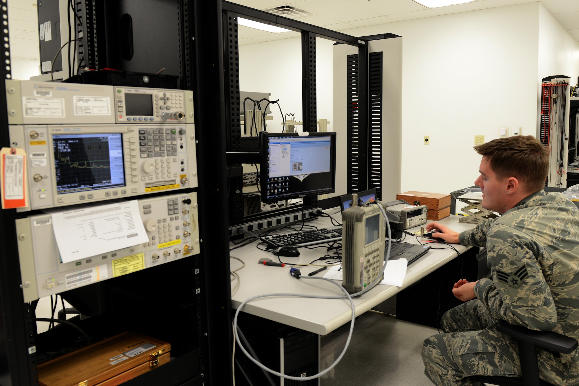 Senior Airman Robert Huber, 56th Component Maintenance Squadron precision measurement equipment laboratory technician, calibrates a navigation communication tester Jan. 24, 2017, at Luke Air Force Base, Ariz. The tester simulates aircraft landing approach communications. (U.S. Air Force photo by Airman 1st Class Pedro Mota)