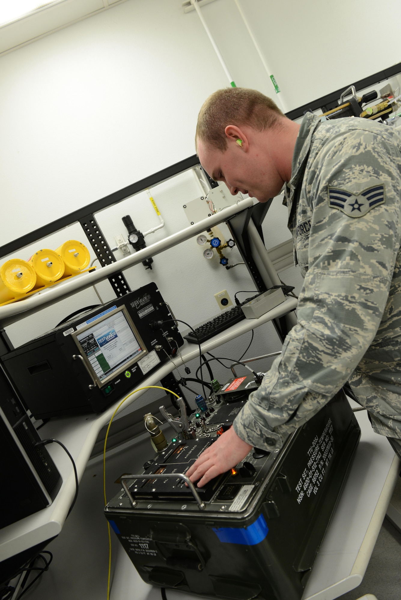 Senior Airman Daniel Bergin, 56th Component Maintenance Squadron precision measurement equipment laboratory technician, calibrates an air speed altitude tester Jan. 24, 2017, at Luke Air Force Base, Ariz. The tester is used for the F-16 fighting falcon to simulate air speed and altitude for the aircraft to ensure the instrument on the aircraft is reading at the correct levels. (U.S. Air Force photo by Airman 1st Class Pedro Mota)
