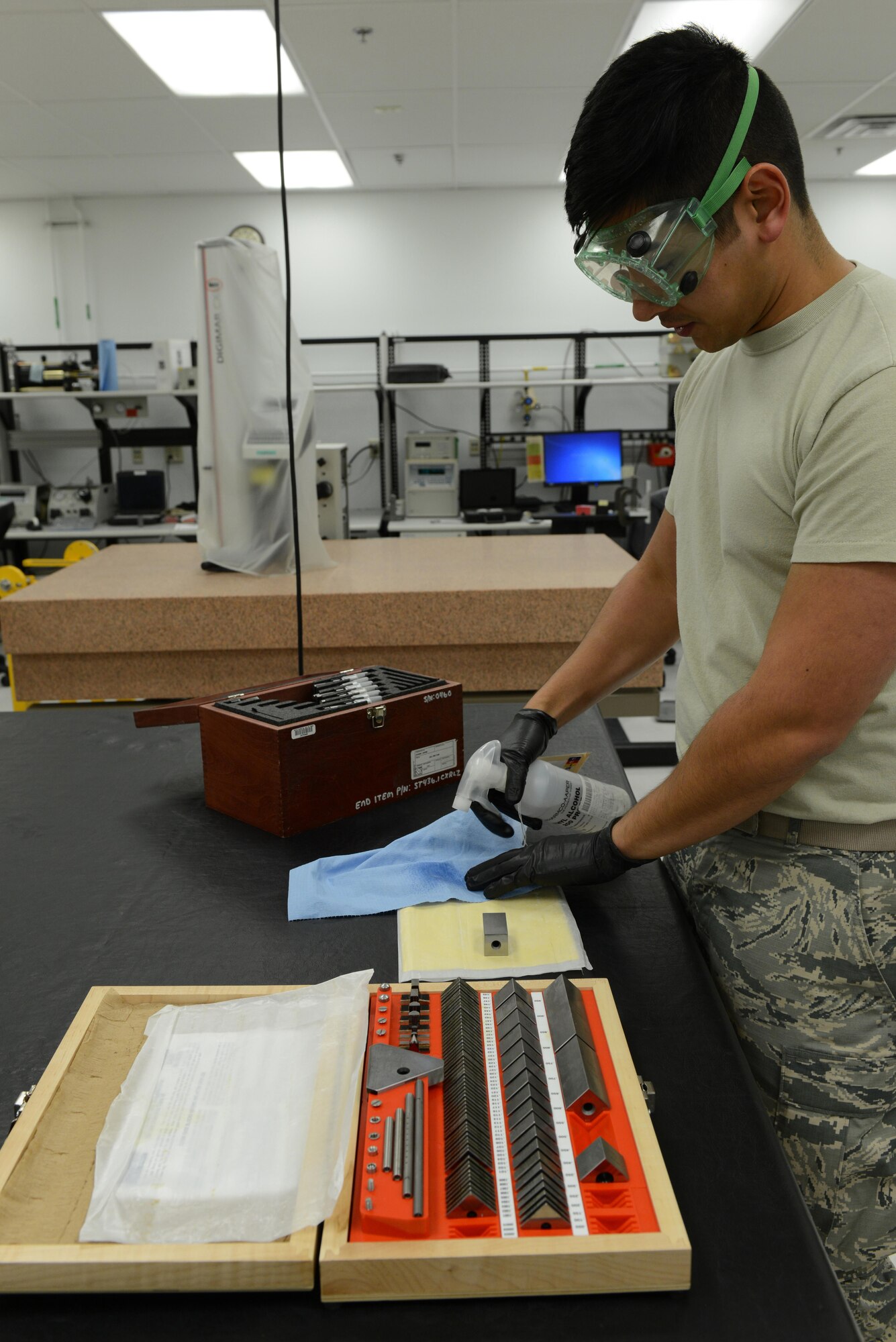 Senior Airman Donald Area, 56th Component Maintenance Squadron precision measurement equipment laboratory technician, cleans gauge blocks with ethyl alcohol Jan. 24, 2017, at Luke Air Force Base, Ariz. The gauge blocks are used to calibrate micrometers for fabrication flight spacing or depth measurements on an aircraft. (U.S. Air Force photo by Airman 1st Class Pedro Mota)