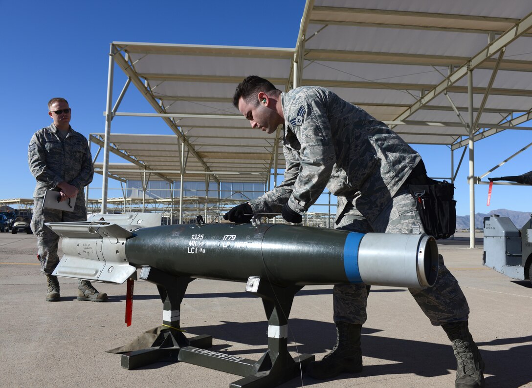Senior Airman Derek Thayer, 310th Aircraft Maintenance Unit aircraft armament, prepares to load a GBU-12 bomb during the annual Load Crew Competition Jan. 27, 2017, at Luke Air Force Base, Ariz. Airmen from various AMUs competed by loading weapons on their respective aircraft aiming for the fastest and safest time possible. (U.S. Air Force photo by Airman 1st Class Alexander Cook)