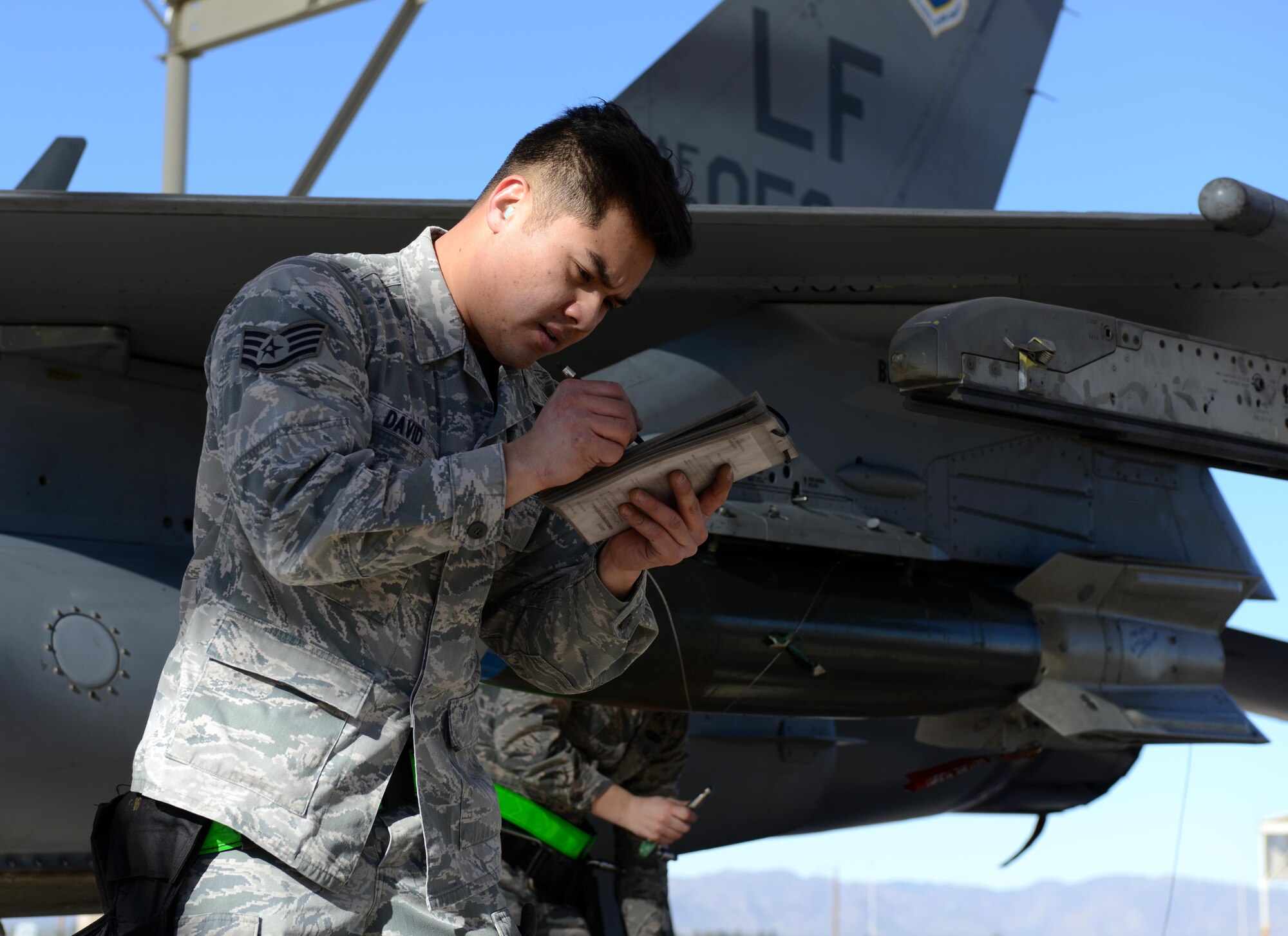 Staff Sgt. Dranel David, 310th AMU weapons standardization load crew team member, annotates data during the annual Load Crew Competition Jan. 27, 2017, at Luke Air Force Base, Ariz. During the Competition, Airmen in each team performed different jobs to safely and successfully complete the mission in the least amount of time. (U.S. Air Force photo by Airman 1st Class Alexander Cook)