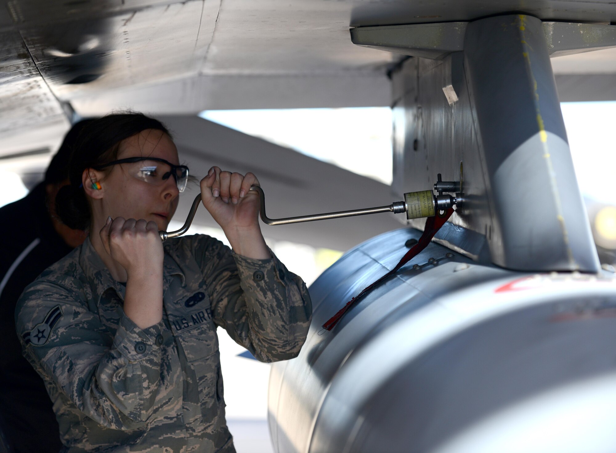 Airman 1st Class Kathryn Decker 310th Aircraft Maintenance Unit weapons load team member, prepares a GBU-12 bomb during the Annual Load Crew Competition Jan. 27, 2017, at Luke Air Force Base, Ariz. Teams consisted of three Airmen each from various AMUs working together to successfully load weapons on an F-16 Fighting Falcon or the F-35 Lightning II aircraft. (U.S. Air Force photo by Airman 1st Class Alexander Cook) 