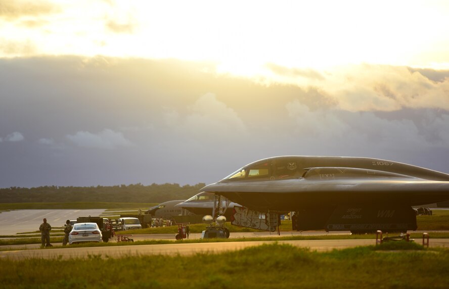 The sunset filters through the cockpit windows of two U.S. Air Force B-2 Spirits deployed from Whiteman Air Force Base, Mo., after completing local training missions at Andersen Air Force Base, Guam, Jan. 17, 2017. Strategic bomber missions enhance the readiness and training necessary to respond to any potential crisis or challenge across the globe. (U.S. Air Force photo by Airman 1st Class Jazmin Smith)