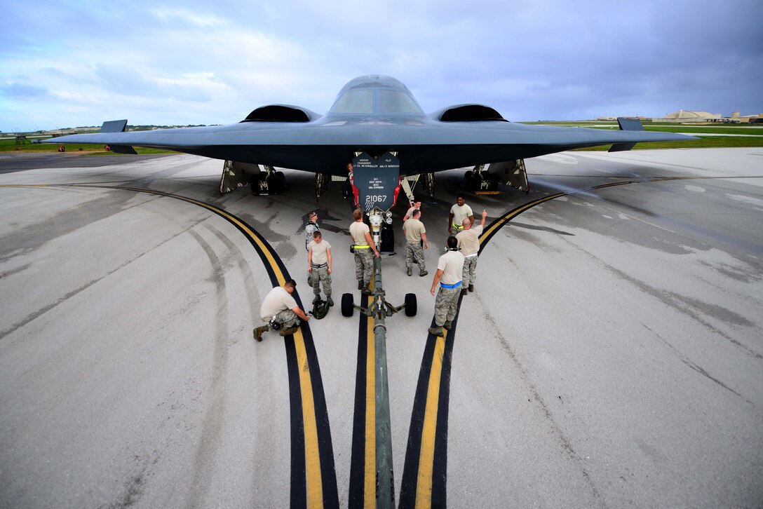 U.S. Air Force maintenance technicians assigned to the 509th Aircraft Maintenance Squadron, Whiteman Air Force Base, Mo., discuss and prepare a U.S. Air Force B-2 Spirit aircraft to be towed after a local training mission at Anderson Air Force Base, Guam Jan. 19, 2017. Close to 200 Airmen from Whiteman Air Force Base, Mo., and Barksdale Air Force Base, La., deployed to Andersen AFB, in support of U.S. Strategic Command Bomber and Deterrence missions. USSTRATCOM bomber missions familiarize aircrew with airbases and operations in different Geographic Combatant Commands. (U.S. Air Force photo by Tech. Sgt. Andy M. Kin)