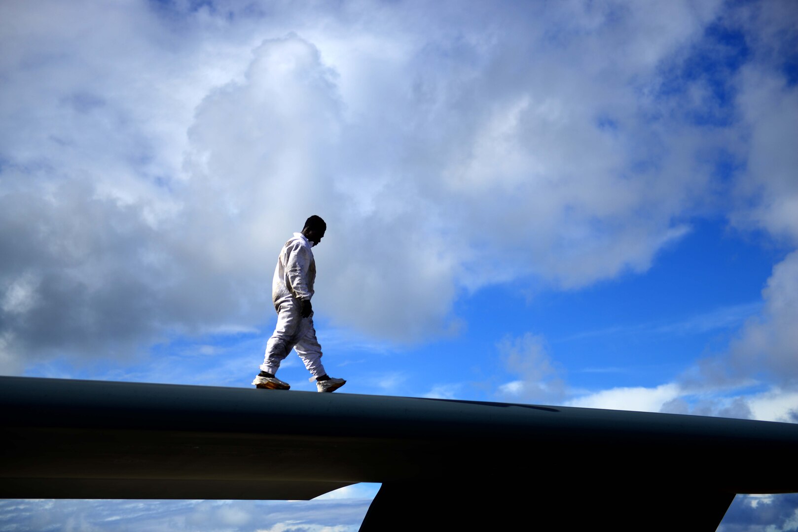 U.S. Air Force Staff Sgt. Elijah Fleming, a crew chief assigned to the 509th Aircraft Maintenance Squadron, walks on top of the B-2 Spirit aircraft while performing post-flight inspections after a local training at Andersen Air Force Base, Guam, Jan. 17, 2017. Close to 200 Airmen from Whiteman Air Force Base, Mo., and Barksdale Air Force Base, La., deployed to Andersen AFB, in support of U.S. Strategic Command Bomber and Deterrence missions. USSTRATCOM bomber missions familiarize aircrew with airbases and operations in different Geographic Combatant Commands. (U.S. Air Force photo by Tech Sgt. Andy M. Kin)