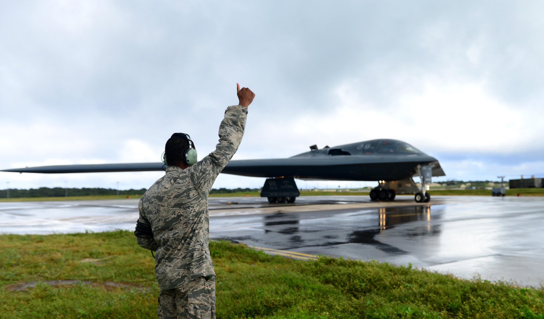 U.S. Air Force Senior Airman Dez Starkes, a crew chief assigned to the 509th Aircraft Maintenance Squadron, signals to the mission commander that he is clear and free to move forward at Andersen Air Force Base, Guam, Jan. 12, 2017. Strategic bomber missions enhance the readiness and training necessary to respond to any potential crisis or challenge across the globe. (U.S. Air Force photo by Airman 1st Class Jazmin Smith)