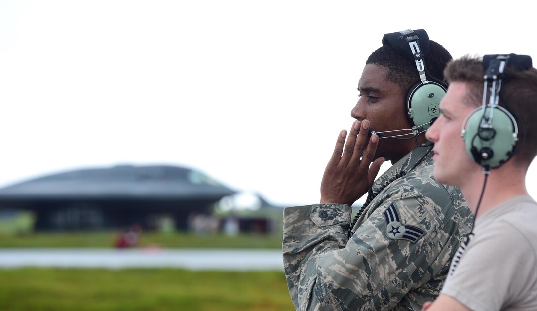 U.S. Air Force Senior Airman Dez Starkes (left) and Senior Airman Hayden Thayer, both crew chiefs assigned to the 509th Aircraft Maintenance Squadron, communicate pre-flight instructions with a B-2 Spirit pilot prior to takeoff at Andersen Air Force Base, Guam, Jan. 12, 2017. U.S. Strategic Command (USSTRATCOM) units regularly conduct training with and in support of the Geographic Combatant Commands. USSTRATCOM, through its global strike assets, helps maintain global stability and security while enabling units to become familiar with operations in different regions. (U.S. Air Force photo by Airman 1st Class Jazmin Smith)