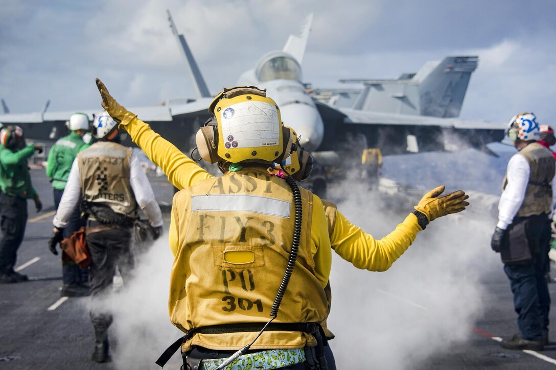 Sailors use hand signals while conducting flight operations on the flight deck aboard the aircraft carrier USS Carl Vinson in the Pacific Ocean, Jan. 25, 2017. The Carl Vinson Carrier Strike Group will report to U.S. 3rd Fleet, headquartered in San Diego, while deployed to the Western Pacific as part of the U.S. Pacific Fleet-led initiative to extend the command and control functions of 3rd Fleet into the region. Navy photo by Petty Officer 2nd Class Sean M. Castellano