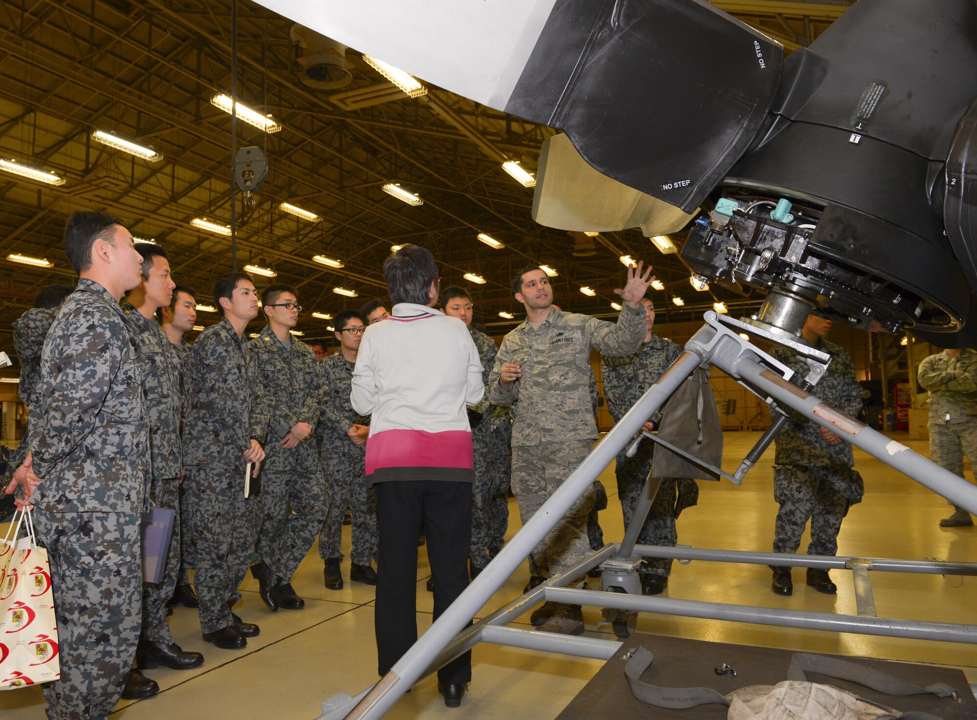 Staff Sgt. Vincent Pizzelo, 374th Maintenance Squadron propulsion flight propulsion journeyman, explains the structure of C-130H Hercules engines and propellers to Japan Air Self Defense Force maintenance officers-in-training at Yokota Air Base, Japan, Jan. 25, 2017. The JASDF officers visited Yokota maintenance shops and discovered how Yokota MXG operates in order to understand and learn from their differences. Interactive bilateral visits are designed to strengthen Japan-U.S. relations and improve how they operate together. (U.S. Air Force photo by Senior Airman Elizabeth Baker)