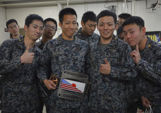 Japan Air Self Defense Force maintenance officers-in-training pose for a photo with a 374th Maintenance Squadron aircraft metals technology flight at Yokota Air Base, Japan, Jan. 25, 2017. The JASDF officers visited Yokota maintenance shops, spoke with personnel and observed operations in order to understand and learn from their differences. Interactive bilateral visits are designed to strengthen Japan-U.S. relations and improve how they operate together. (U.S. Air Force photo by Senior Airman Elizabeth Baker)