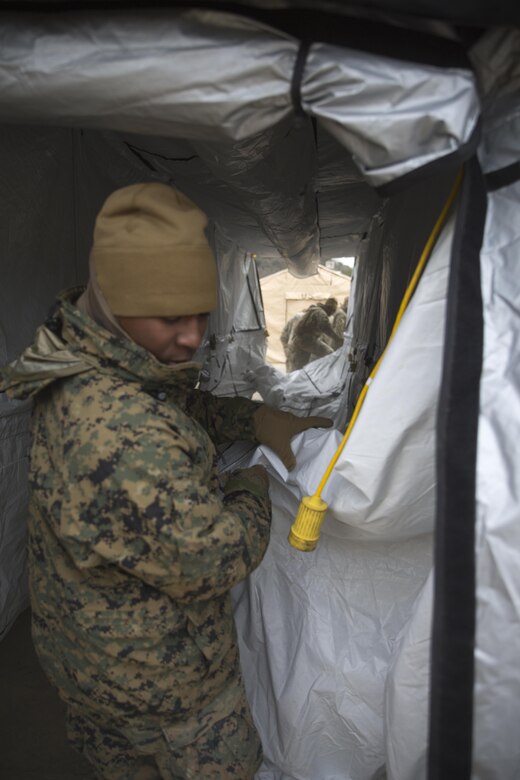 U.S. Marines with Marine Wing Support Sqaudron 171 disassemble a 305 tent during exercise Kamoshika Wrath 17-1 at Haramura Maneuver Area, Hiroshima, Japan, Jan. 27, 2017. The Marines worked through inclement weather conditions and a short timeline to build a 96-foot by 96-foot vertical takeoff and landing pad. The exercise is a biannual, unit-level training exercise that is primarily focused on establishing a forward operating base and providing airfield operation services. MWSS-171 trains throughout the year completing exercises like Kamoshika Wrath to enhance their technical skills, field experience and military occupational specialty capability. (U.S. Marine Corps photo by Cpl. Donato Maffin)