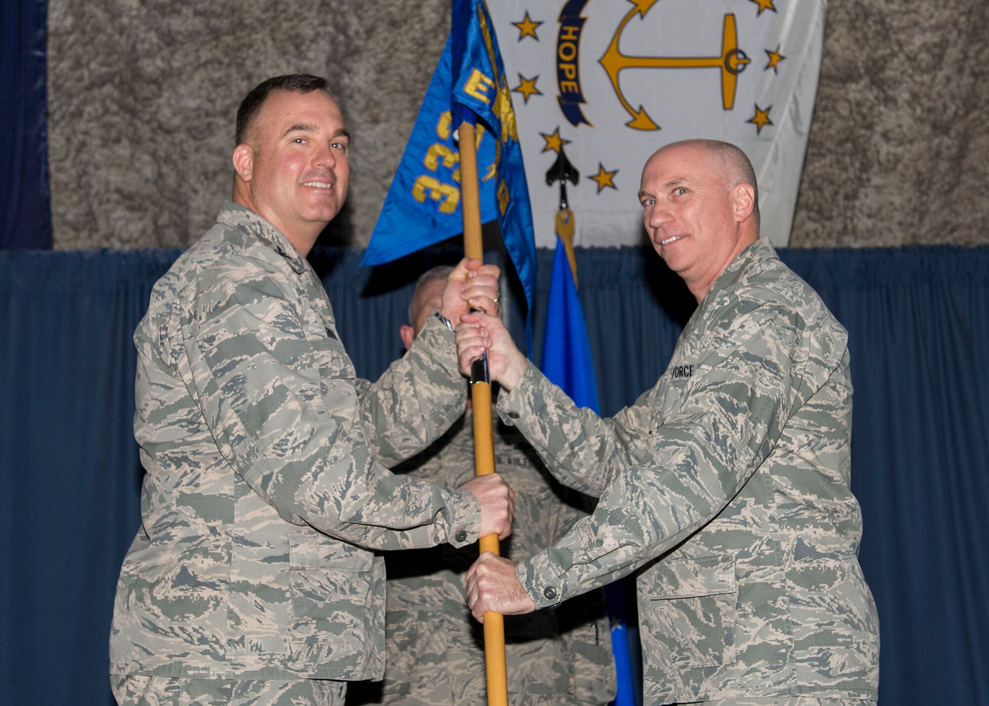 U.S. Air Force Maj. Dennis Regan, 332nd Expeditionary Communication Squadron incoming commander, receives command from Col. Daniel Guinan, 332nd Expeditionary Mission Support Group commander, during a change of command ceremony Jan. 19, 2017, at an undisclosed location in Southwest Asia. (U.S. Air Force photo by Staff Sgt. Eboni Reams/Released)
