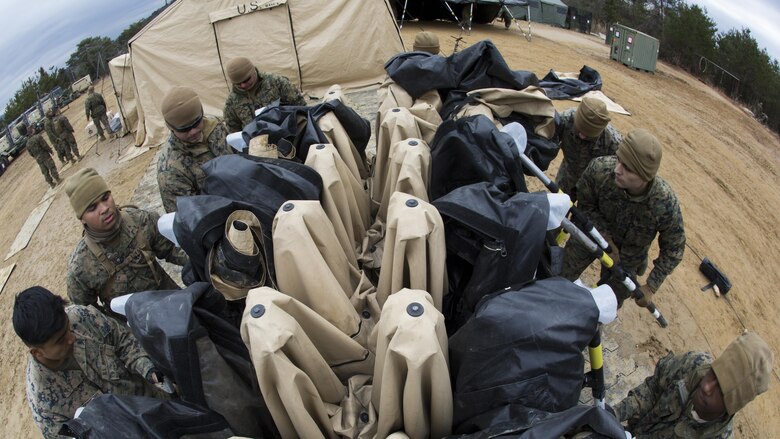 U.S. Marines with Marine Wing Support Sqaudron 171 fold a 305 tent during exercise Kamoshika Wrath 17-1 at Haramura Maneuver Area, Hiroshima, Japan, Jan. 27, 2017. The Marines worked through inclement weather conditions and a short timeline to build a 96-foot by 96-foot vertical takeoff and landing pad. The exercise is a biannual, unit-level training exercise that is primarily focused on establishing a forward operating base and providing airfield operation services. MWSS-171 trains throughout the year completing exercises like Kamoshika Wrath to enhance their technical skills, field experience and military occupational specialty capability. 