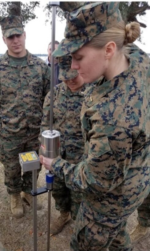 On January 5, 2017, Marines attached to Combat Engineer Officer course 2-17 (CEO 2-17) conduct a soils stabilization test.  CEO students learn how to analyze soil stability and incorporate the results into their planning process for construction.  Pictured from left to right are Second Lieutenants Chase Alexanian, Beth Park, and Margo Darragh. 

