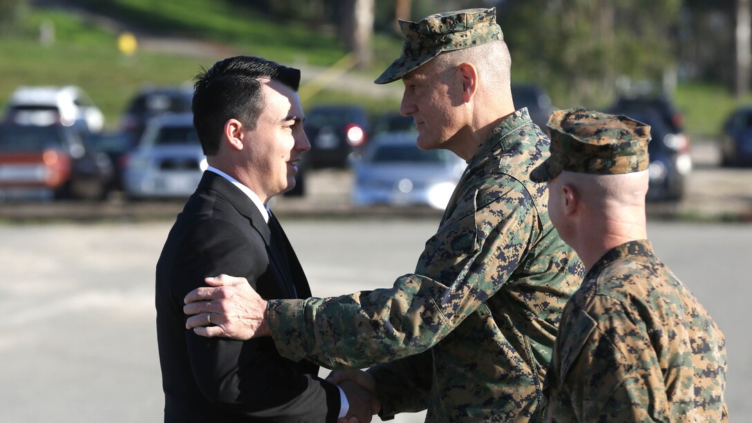 Sgt. Zachary L. Piepenhagen (left), shakes hands with Maj. Gen. David Coffman, deputy commanding general, I Marine Expeditionary Force, after being awarded the Navy and Marine Corps Medal at Marine Corps Base Camp Pendleton, California, Jan. 26, 2017. Piepenhagen was awarded the medal for saving the life of a distressed Sailor who climbed over the guard rail in an attempt to commit suicide while serving with the 13th Marine Expeditionary Unit. 