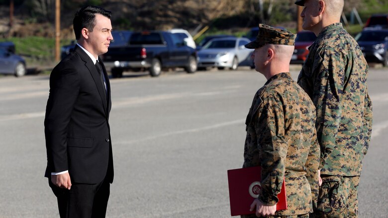 Sgt. Zachary L. Piepenhagen (left), stands at attention as Maj. Gen. David Coffman (right), deputy commanding general, I Marine Expeditionary Force, awards him the Navy and Marine Corps Medal at Marine Corps Base Camp Pendleton, California, Jan. 26, 2017. Piepenhagen was awarded the medal for saving the life of a distressed Sailor who climbed over the guard rail in an attempt to commit suicide while serving with the 13th Marine Expeditionary Unit. 